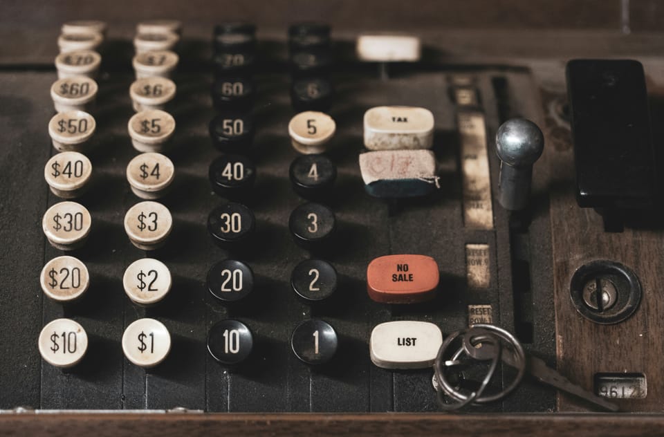 photo of a vintage adding machine with numbered dials